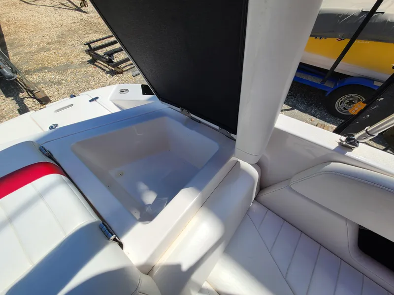 Slide: The Image of 2007 Regal 2200 Bowrider boat interior with open storage compartment and white seating. - 30