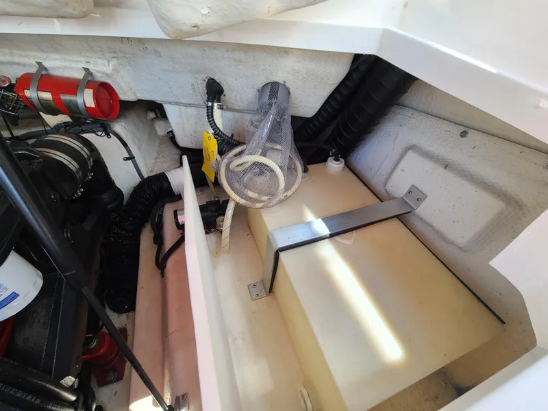 Slide: The Image of Engine compartment of a 2007 Regal 2200 Bowrider boat, showing mechanical components and storage. - 31