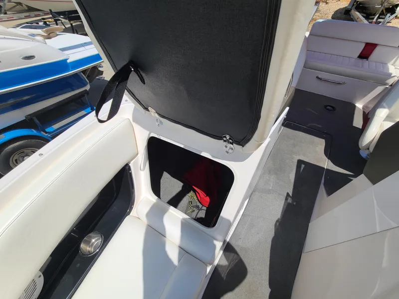 Slide: The Image of 2007 Regal 2200 Bowrider interior with open storage compartment and seating. - 35