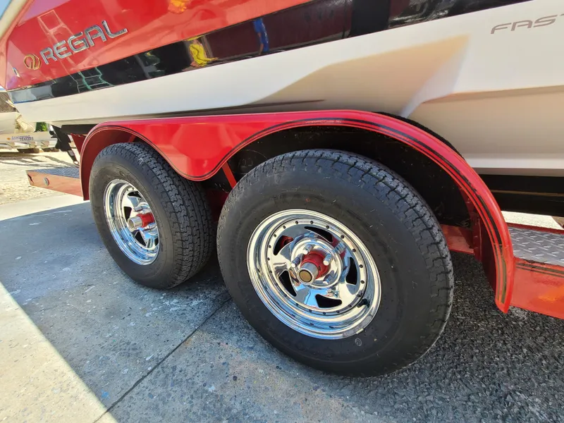 Slide: The Image of 2007 Regal 2200 Bowrider trailer with dual wheels and chrome rims. - 40