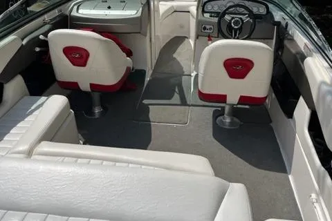 Slide: The Image of 2007 Regal 2200 Bowrider interior with white and red seating, steering wheel, and dashboard. - 43
