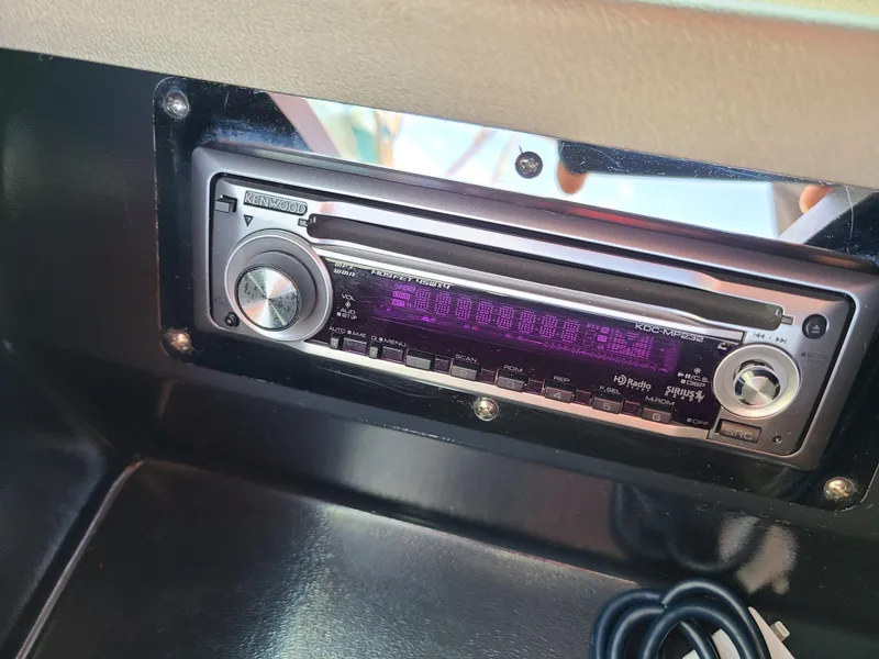 Slide: The Image of Kenwood stereo system in a 2007 Regal 2200 Bowrider boat dashboard. - 44