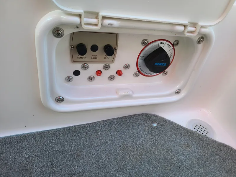 Slide: The Image of Control panel of a 2007 Regal 2200 Bowrider boat, featuring switches and dials. - 45