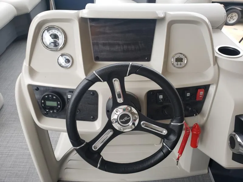 Slide: The Image of 2024 SunChaser Vista 22 LR boat dashboard with steering wheel and control panel. - 10