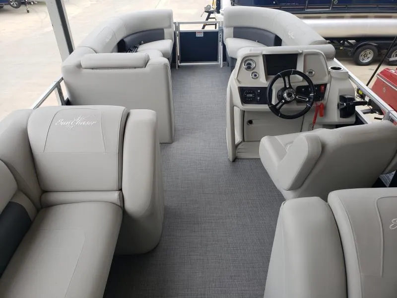 Slide: The Image of 2024 SunChaser Vista 22 LR pontoon boat interior with plush seating and modern helm. - 12