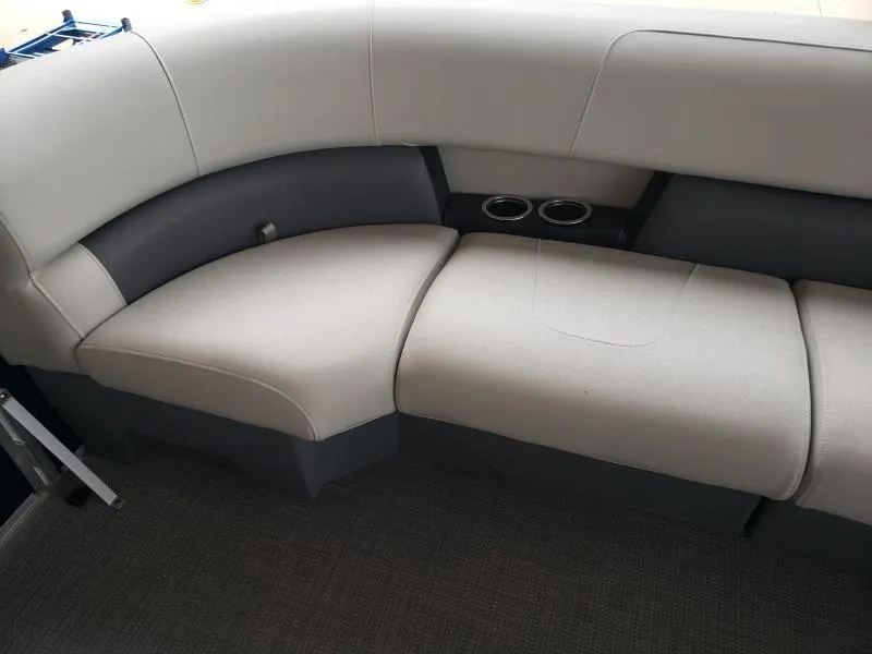 Slide: The Image of 2024 SunChaser Vista 22 LR boat seating with cup holders, featuring light gray upholstery. - 14