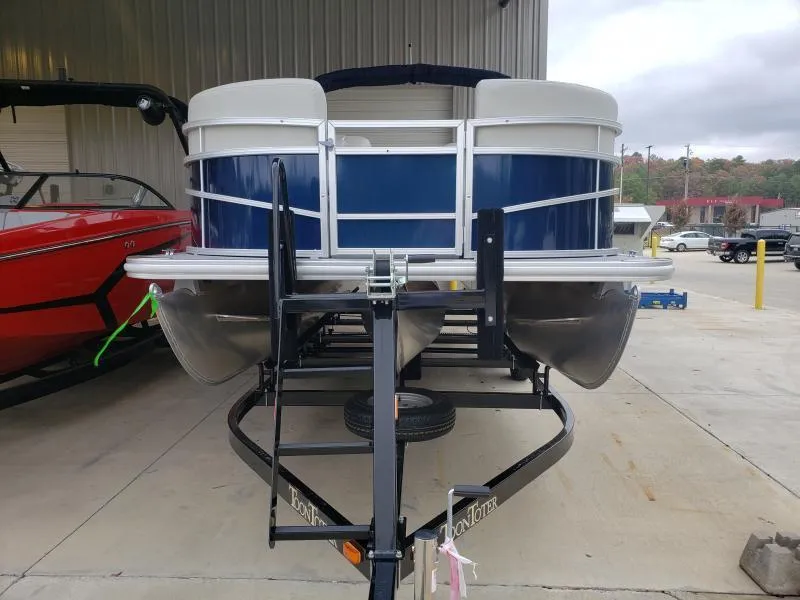 Slide: The Image of 2024 SunChaser Vista 22 LR pontoon boat on trailer, parked in a marina. - 3