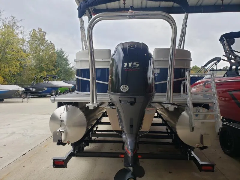 Slide: The Image of 2024 SunChaser Vista 22 LR pontoon boat with 115 horsepower engine, parked on trailer. - 6