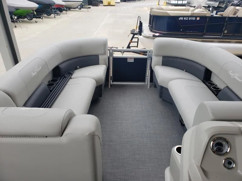 Slide: The Image of 2024 SunChaser Vista 22 LR pontoon boat interior with gray seating and cup holders. - 9