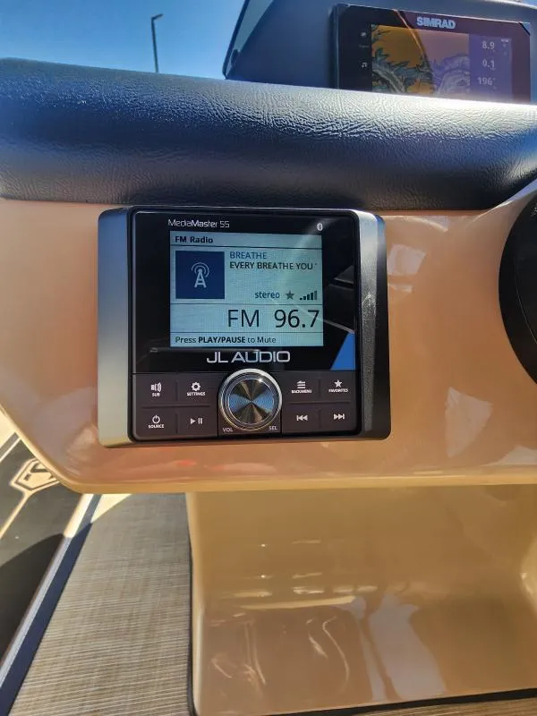 Slide: The Image of JL Audio MediaMaster 55 on 2025 Harris Boats SUNLINER 230 dashboard, displaying FM radio station 96.7. - 13