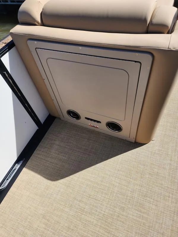 Slide: The Image of 2025 Harris Boats SUNLINER 230 interior with beige seating and integrated speakers. - 17