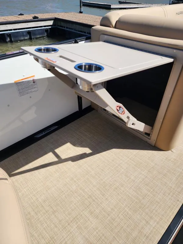 Slide: The Image of 2025 Harris Boats SUNLINER 230 with foldable table and cup holders on deck. - 18