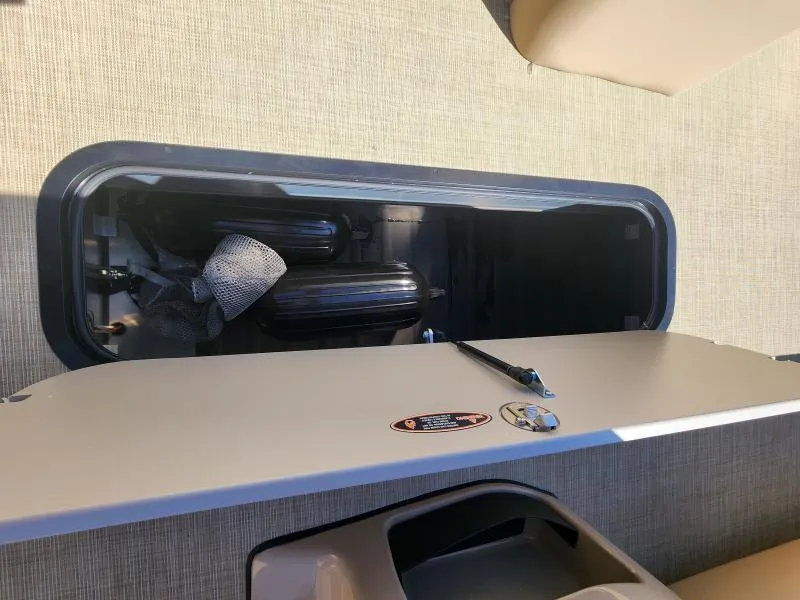 Slide: The Image of Storage compartment on 2025 Harris Boats SUNLINER 230, showcasing interior space and equipment. - 21
