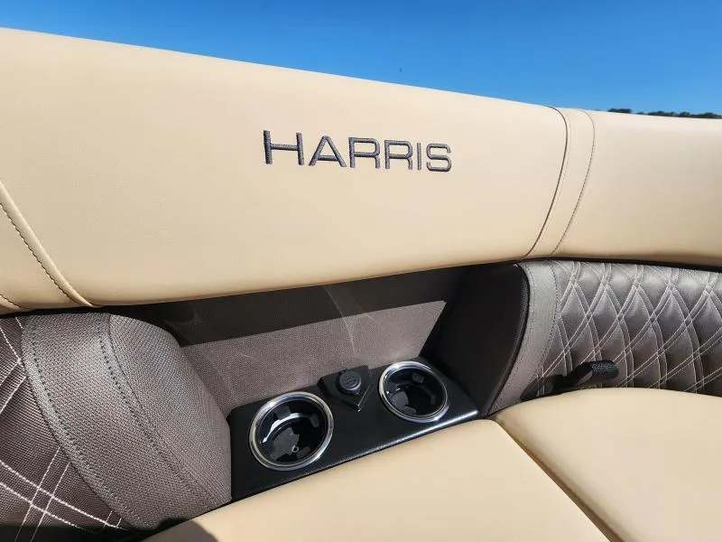 Slide: The Image of 2025 Harris SUNLINER 230 boat interior with beige upholstery and cup holders. - 23