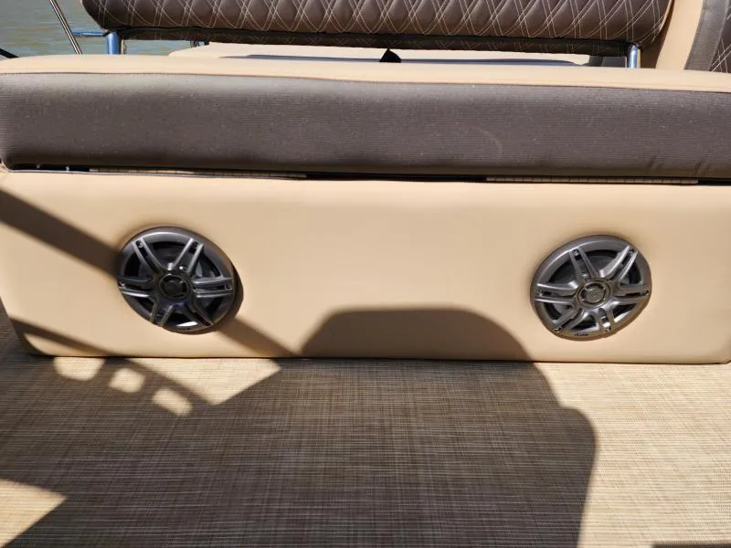 Slide: The Image of 2025 Harris Boats SUNLINER 230 interior with speakers and cushioned seating. - 24