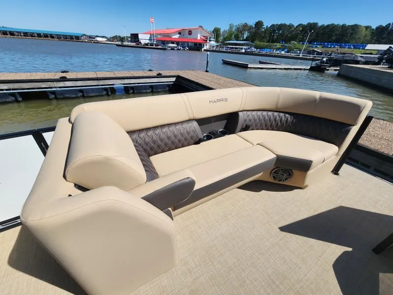 Slide: The Image of 2025 Harris Boats SUNLINER 230 with luxurious seating at a marina dock. - 9