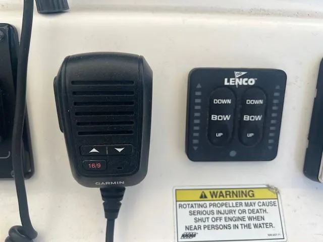 Slide: The Image of Control panel of a 2013 Edgewater 388CC boat with Garmin and Lenco devices. - 10