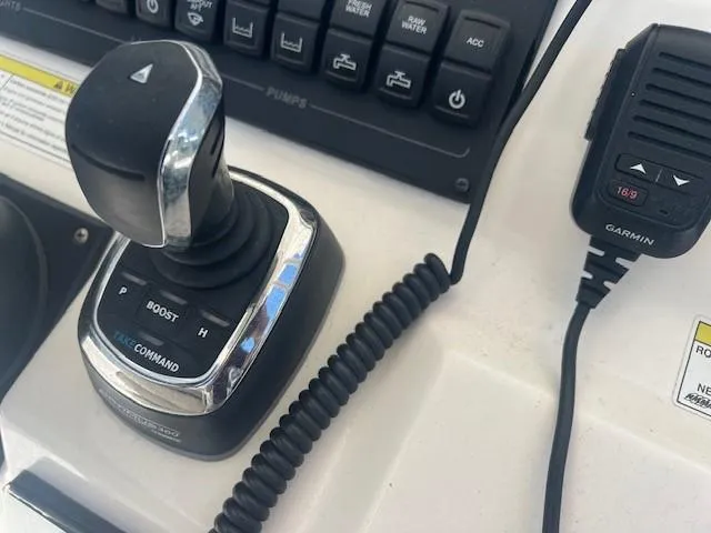 Slide: The Image of Joystick control and Garmin device on 2013 Edgewater 388CC boat dashboard. - 11