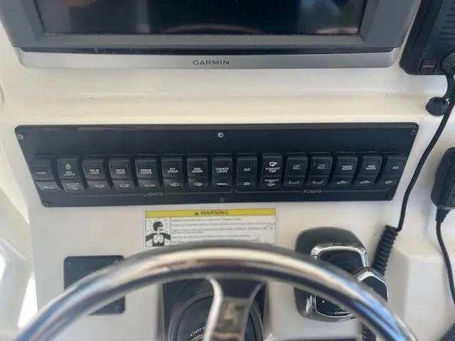 Slide: The Image of Control panel of a 2013 Edgewater 388CC boat with Garmin display and switches. - 12