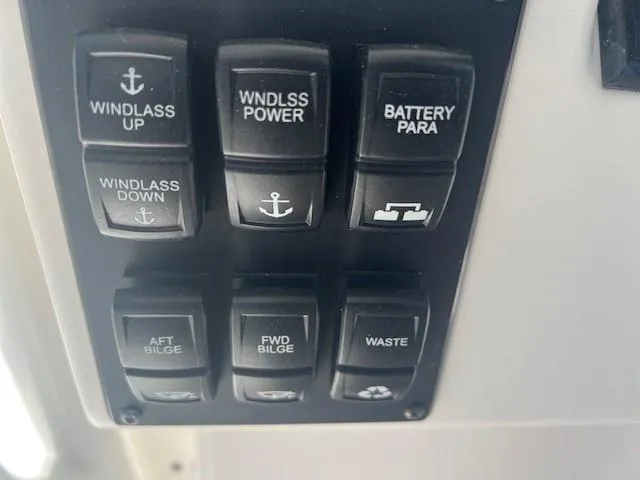 Slide: The Image of Control panel of a 2013 Edgewater 388CC boat with various switches. - 13