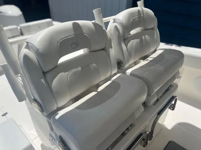 Slide: The Image of White leather seats on a 2013 Edgewater 388CC boat, featuring sleek design and comfort. - 15
