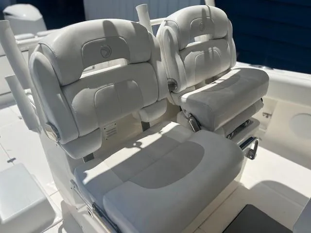 Slide: The Image of Luxurious seating on 2013 Edgewater 388CC boat, featuring plush white cushions. - 16