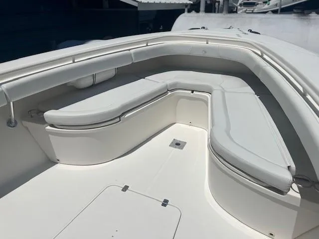 Slide: The Image of 2013 Edgewater 388CC boat with spacious white seating area. - 17