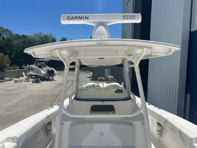 Slide: The Image of 2013 Edgewater 388CC boat with Garmin radar, docked near a warehouse. - 19