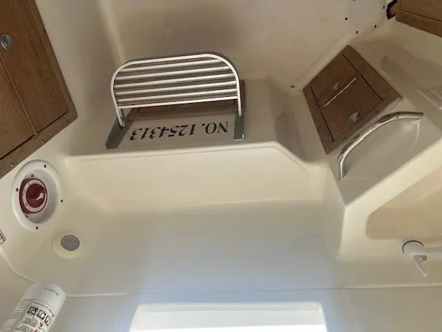 Slide: The Image of Interior view of a 2013 Edgewater 388CC boat cabin with storage compartments. - 22