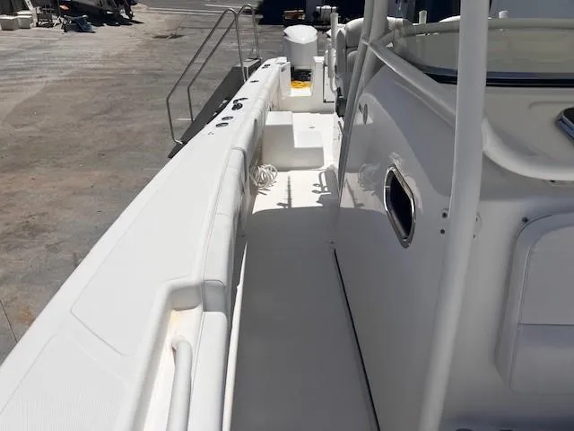 Slide: The Image of 2013 Edgewater 388CC boat deck, featuring sleek white design and spacious layout. - 24