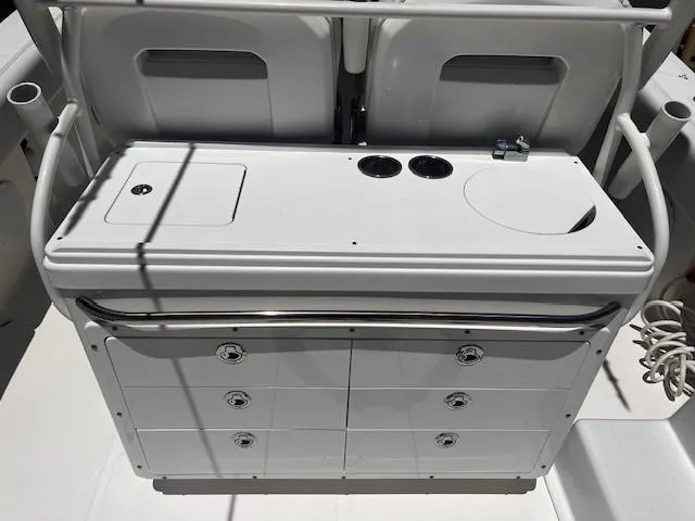 Slide: The Image of Edgewater 388CC 2013 boat console with storage drawers and cup holders. - 26