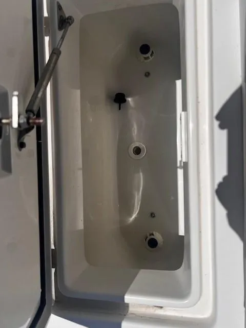Slide: The Image of Open storage compartment on a 2013 Edgewater 388CC boat. - 30