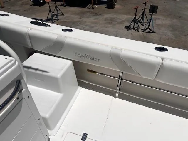 Slide: The Image of Edgewater 388CC boat interior, white seating, rod holders, and deck, 2013 model. - 33