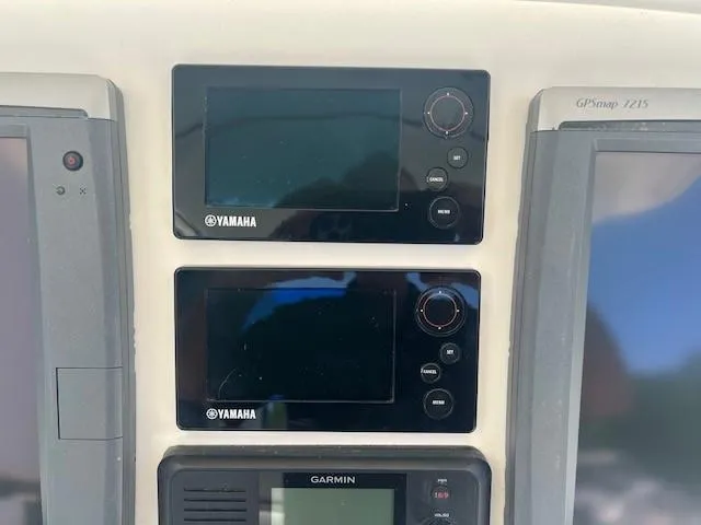 Slide: The Image of Control panel of a 2013 Edgewater 388CC boat with Yamaha and Garmin displays. - 6