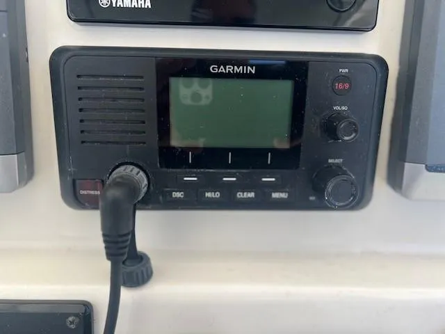 Slide: The Image of Garmin marine radio on 2013 Edgewater 388CC boat dashboard, featuring control buttons and display. - 7