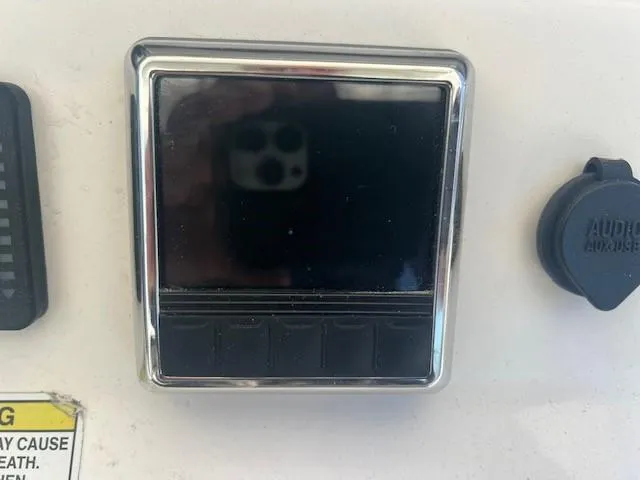 Slide: The Image of Control panel on a 2013 Edgewater 388CC boat dashboard. - 8