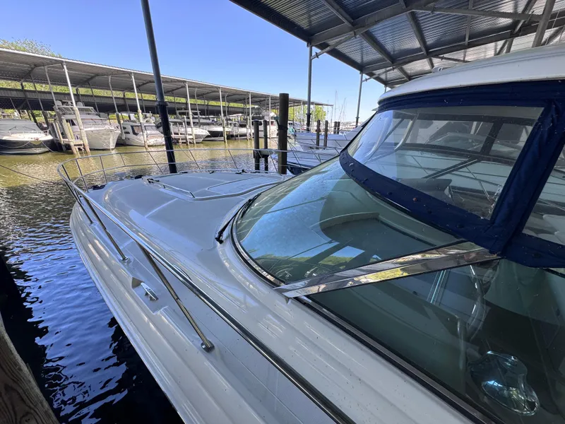 Slide: The Image of 2004 Sea Ray 420 Sundancer docked under a covered marina. - 12