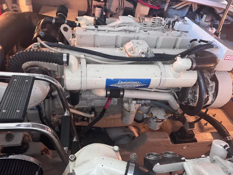 Slide: The Image of Engine of a 2004 Sea Ray 420 Sundancer boat, showcasing mechanical components. - 16