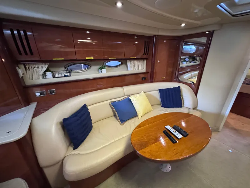 Slide: The Image of Luxurious interior of 2004 Sea Ray 420 Sundancer yacht with plush seating and wooden table. - 18