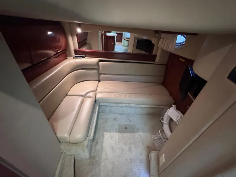 Slide: The Image of Interior of 2004 Sea Ray 420 Sundancer yacht with beige seating and modern amenities. - 20