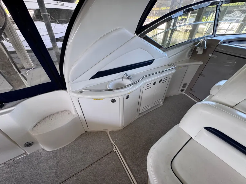 Slide: The Image of 2004 Sea Ray 420 Sundancer interior with sleek white seating and cabinetry. - 6