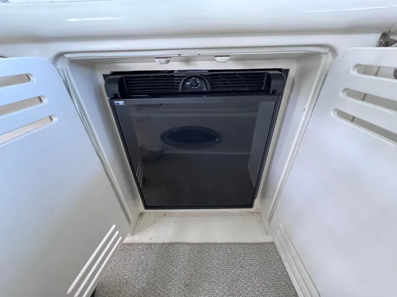 Slide: The Image of 2004 Sea Ray 420 Sundancer mini fridge in white cabinet. - 7