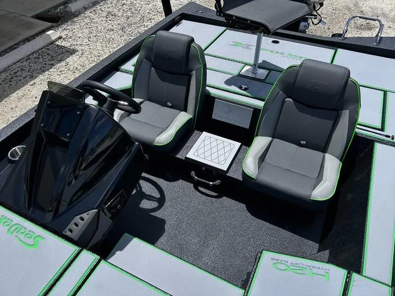 Slide: The Image of 2025 Xpress H20 Bass boat interior with dual seats and steering console. - 11
