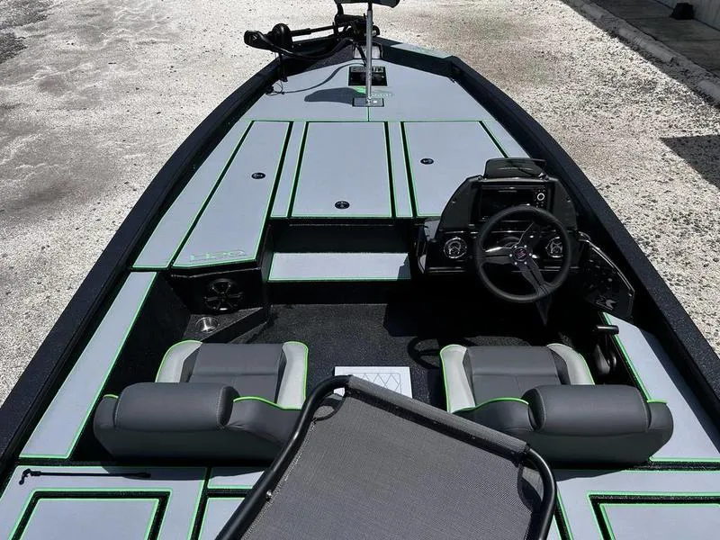 Slide: The Image of 2025 Xpress H20 Bass boat interior with modern seating and steering console. - 14