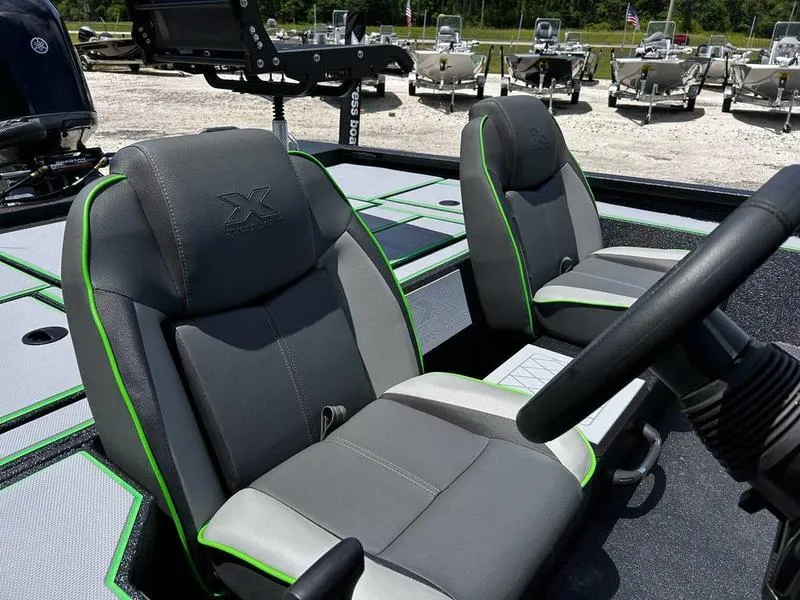 Slide: The Image of 2025 Xpress H20 Bass boat interior with gray and green seats. - 16