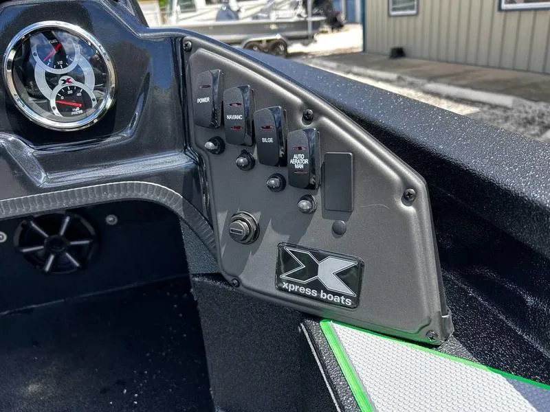 Slide: The Image of Control panel of 2025 Xpress H20 Bass boat with switches and gauge. - 17