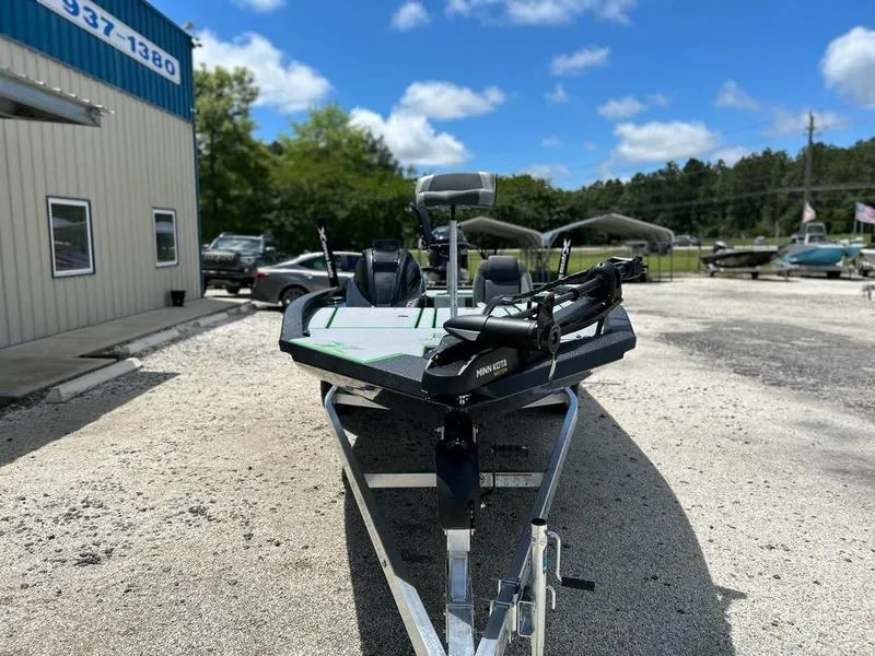 Slide: The Image of 2025 Xpress H20 Bass boat parked outdoors on a sunny day. - 2