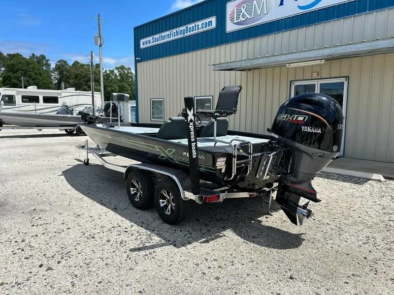 Slide: The Image of 2025 Xpress H20 Bass boat with Yamaha engine, parked outside a dealership. - 3