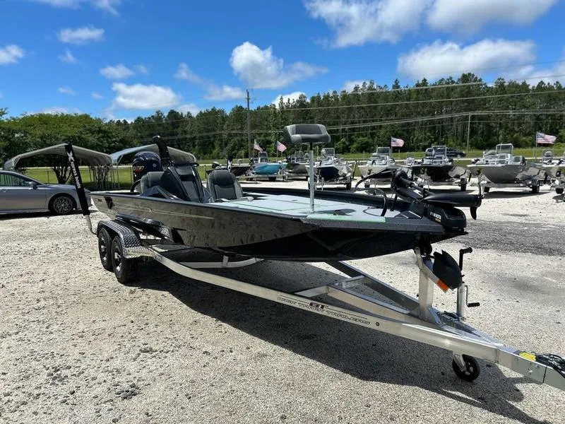 Slide: The Image of 2025 Xpress H20 Bass boat on trailer in outdoor dealership lot. - 6