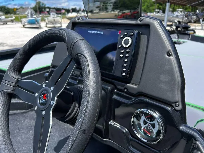 Slide: The Image of 2025 Xpress H20 Bass boat dashboard with steering wheel and electronic display. - 8